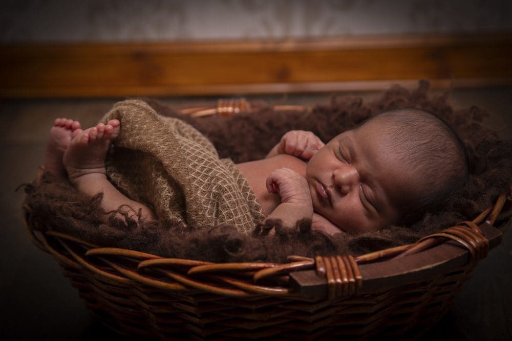 sleeping newborn baby in basket during Birmingham photography studio session