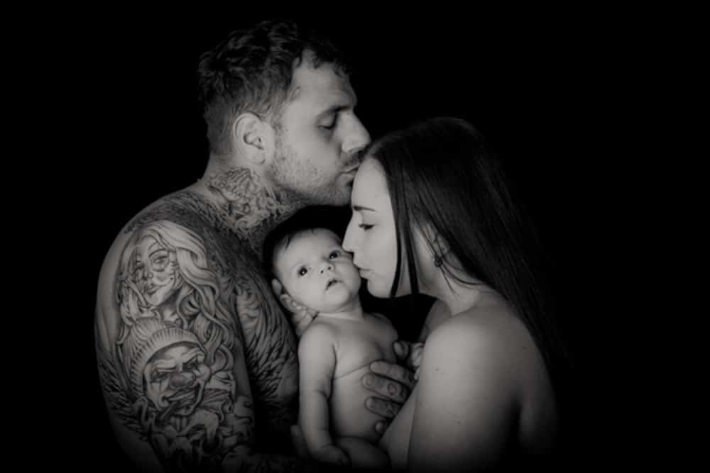 black and white newborn baby skin to skin with parents during Birmingham photography studio session