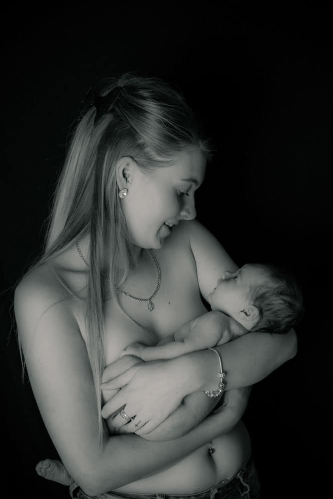 newborn baby skin to skin with mother in Birmingham newborn photography studio portrait