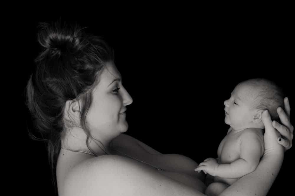 Mother holding newborn baby skin to skin side profile Birmingham