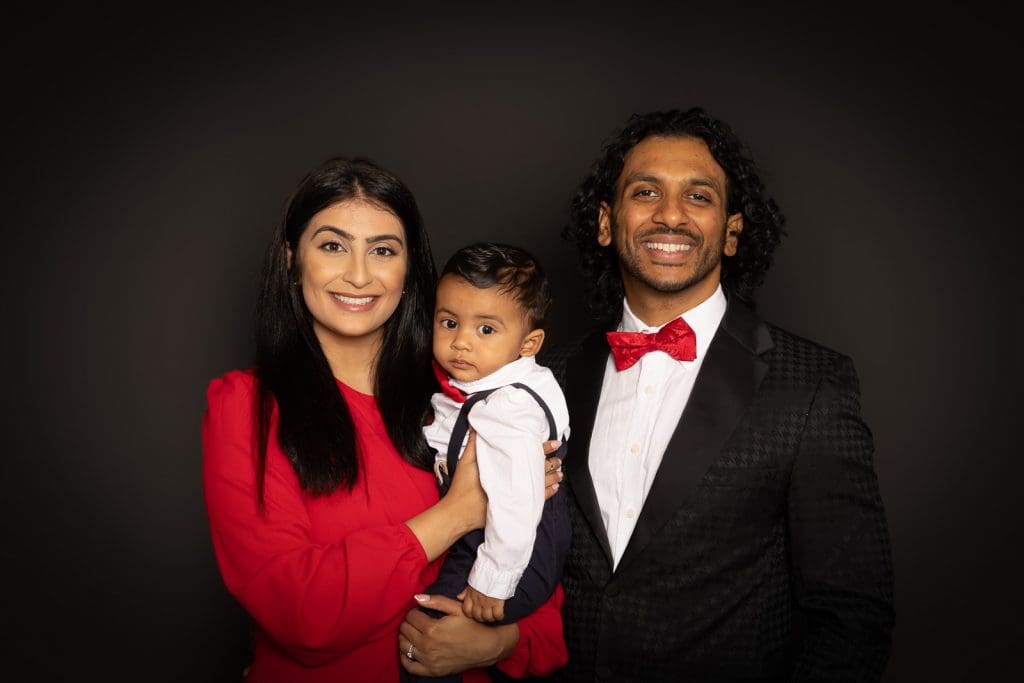 Parents with their baby during a relaxed family photoshoot in Birmingham studio