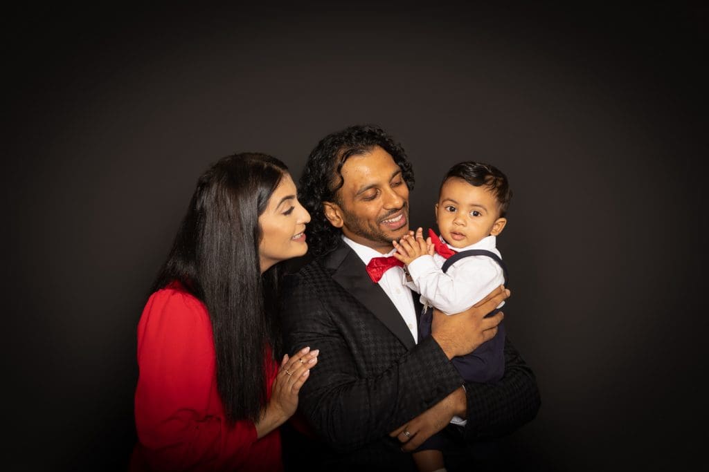 Natural family moment with parents and baby during a Birmingham photoshoot