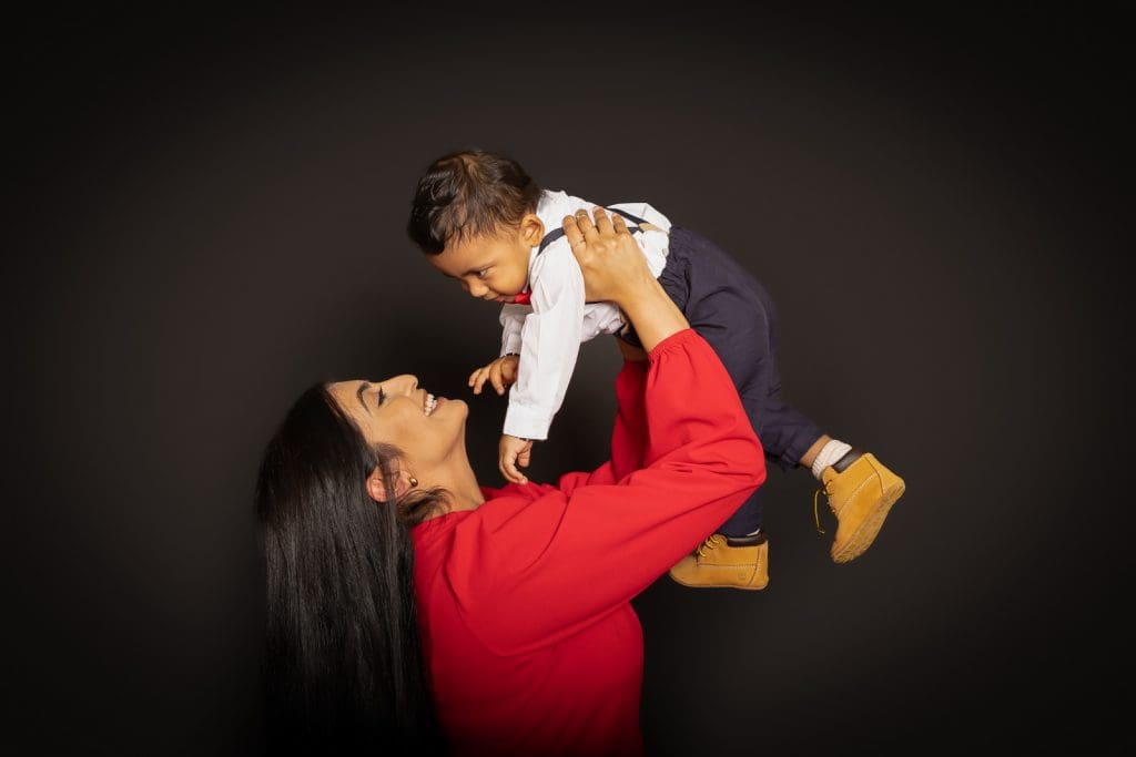 Mother lifting her baby during a joyful family photoshoot in Birmingham