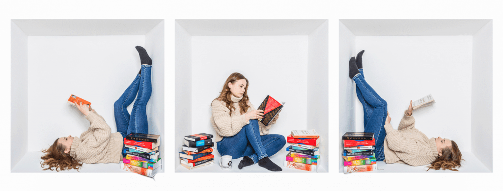 Inside the box photography of a woman reading books inside a white studio box, creating a creative lifestyle portrait.