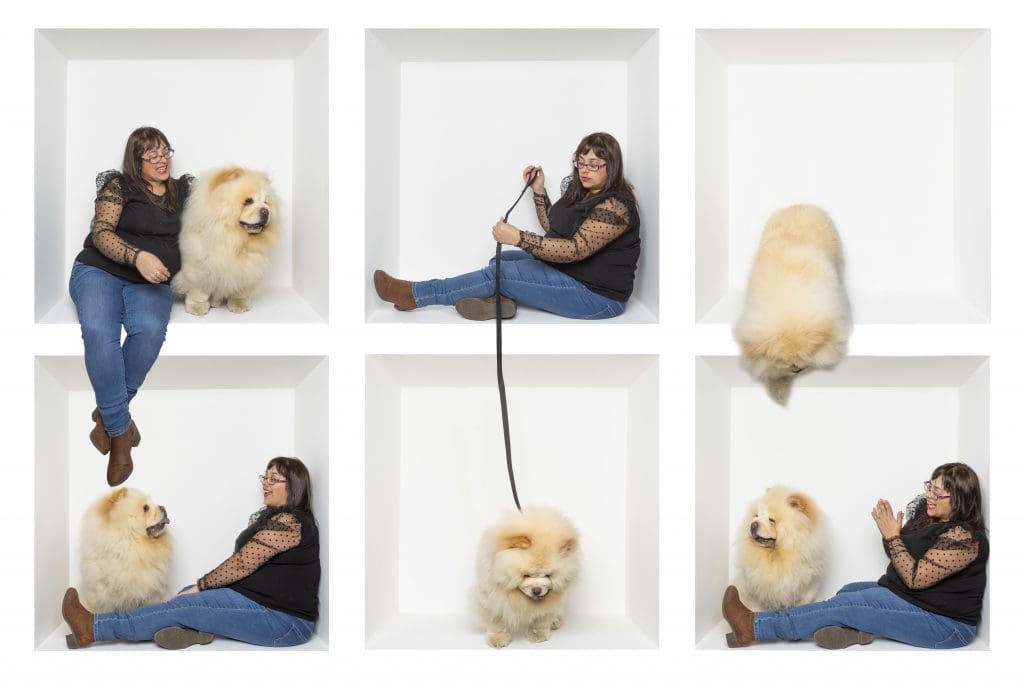 Inside the box photography of a woman and her dog in a white studio box, creating a playful pet portrait series.