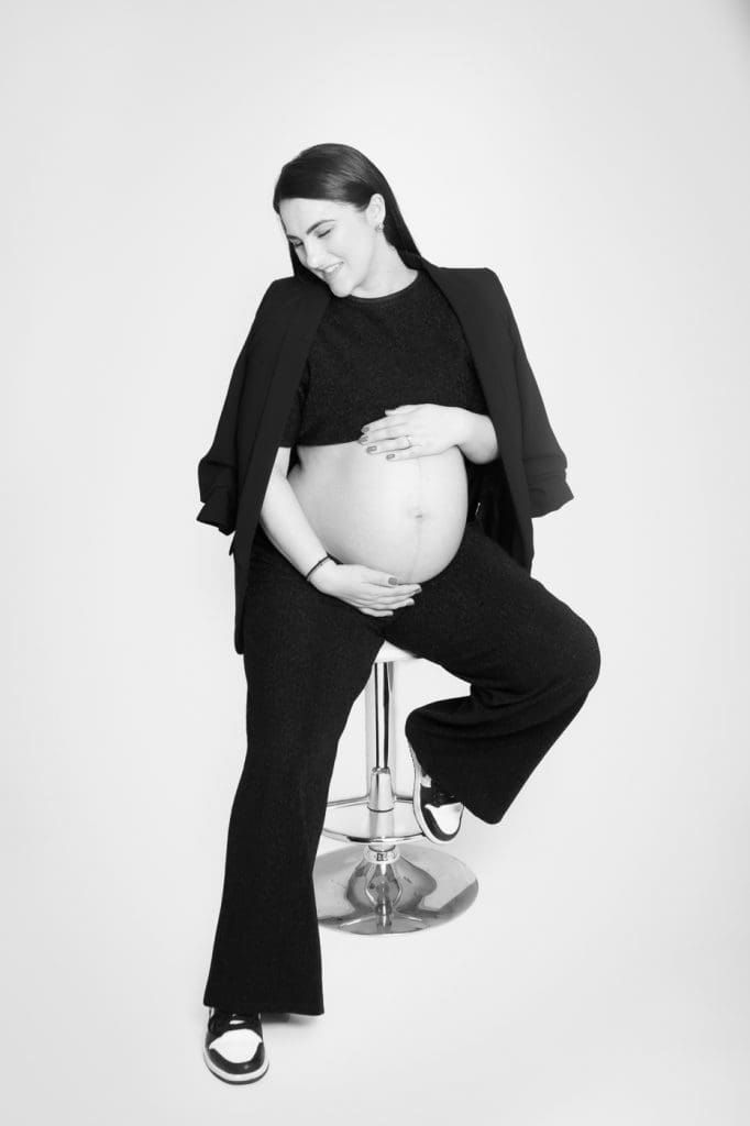 Studio maternity image highlighting natural curves and soft expression