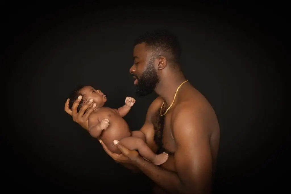 Father holding newborn baby close skin to skin Birmingham