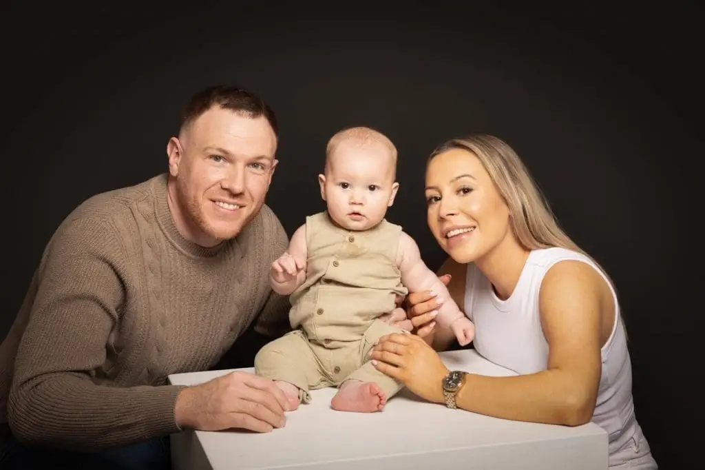family portrait with parents and baby during Birmingham studio photoshoot