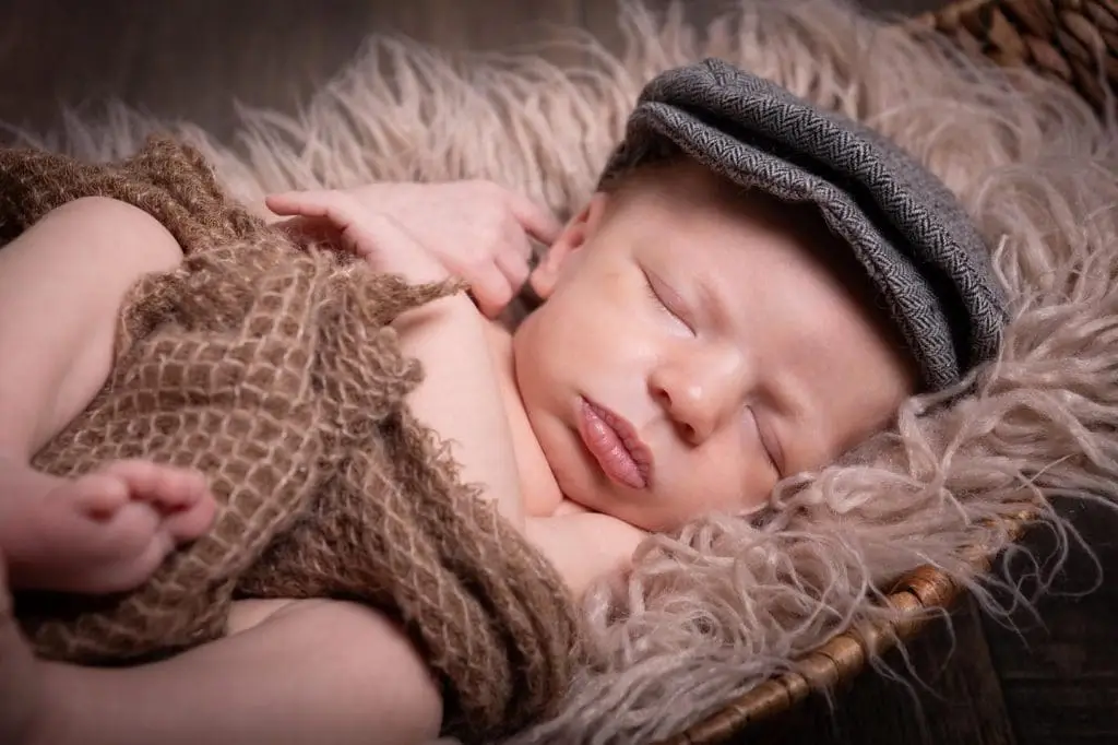 sleeping newborn baby close up portrait in Birmingham photography studio lying in basket