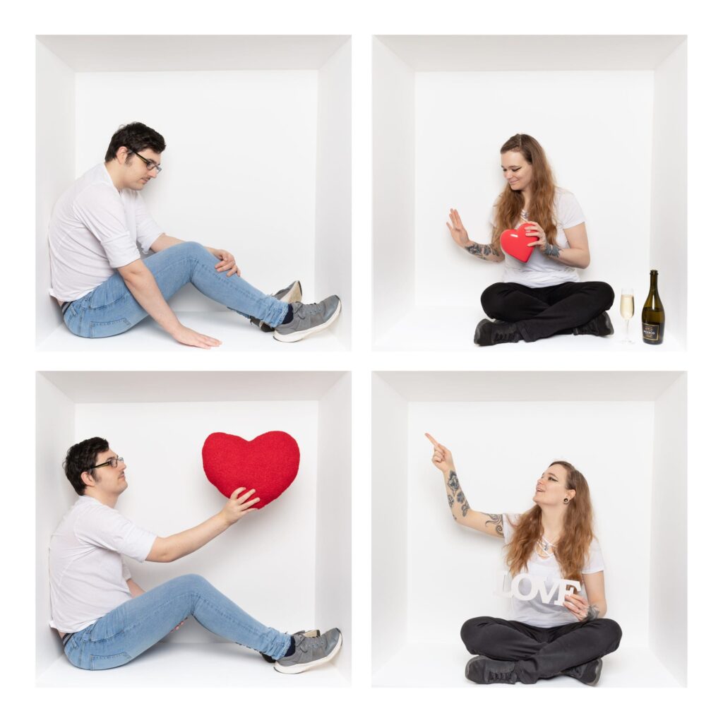 Four white boxes: top left, man sits alone; top right, woman holds a heart, wine glass and bottle beside her; bottom left, man offers a red heart; bottom right, woman smiles, holding a mug and pointing upwards—each moment captured in signature style by a Birmingham inside-the-box photographer.