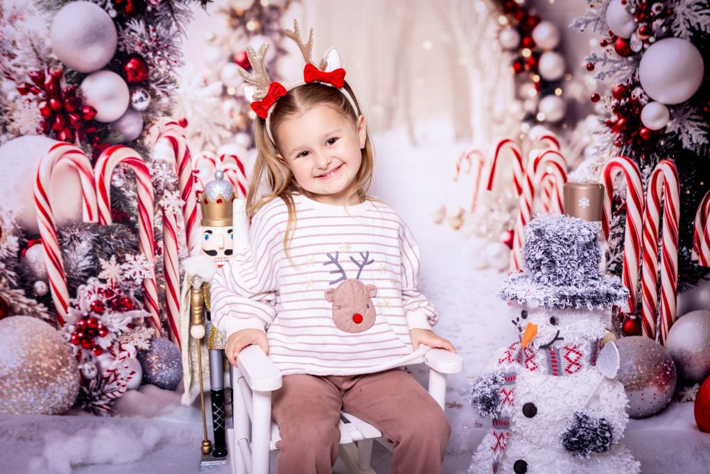 Child in festive setting with snowman